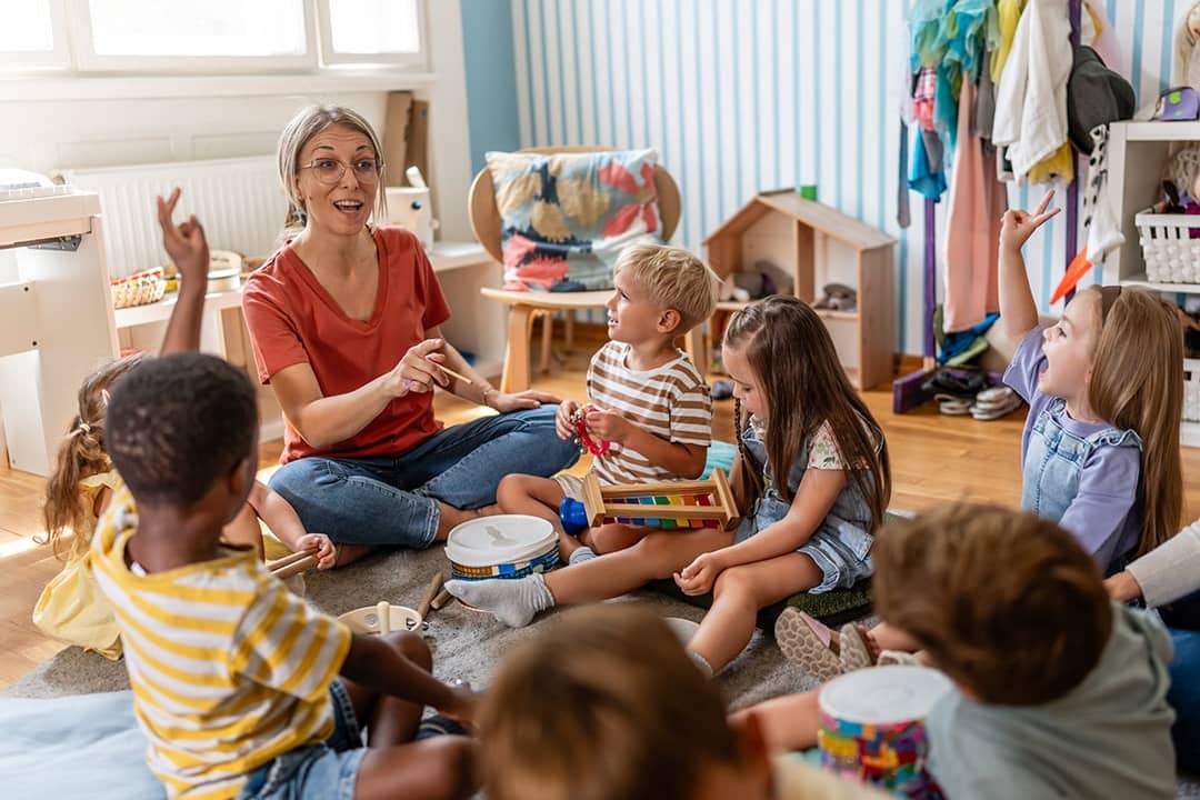 A preschool teacher leading her class with a fun interactive activity.